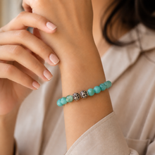 Load image into Gallery viewer, Natural amazonite stone bracelet with 925 sterling silver carved beads worn on wrist, close-up lifestyle shot