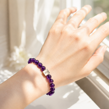 Load image into Gallery viewer, Natural amethyst bead bracelet worn on wrist near window in soft sunlight