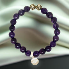 Load image into Gallery viewer, Amethyst bracelet standing upright outdoors with natural green background and silver bead details