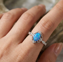 Load image into Gallery viewer, Blue opal silver ring worn on a finger with an elegant oval gemstone design