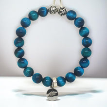 Load image into Gallery viewer, Blue tiger eye bracelet with silver beads and engraved round charm, light grey background