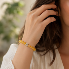 Load image into Gallery viewer, Woman wearing a natural citrine bead bracelet with silver infinity bead in a lifestyle portrait