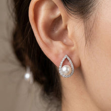 Load image into Gallery viewer, White natural pearl silver teardrop earrings worn on a model's ear
