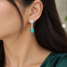 Load image into Gallery viewer, Emerald green gemstone drop earrings in sterling silver with crystal accents worn on a model ear