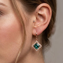 Load image into Gallery viewer, Woman wearing emerald lumina crystal drop earring, close-up on ear.