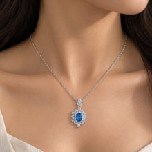 Load image into Gallery viewer, Elegant Flowery Blue Topaz Gemstone Silver Necklace worn on a model | MysticFlavia