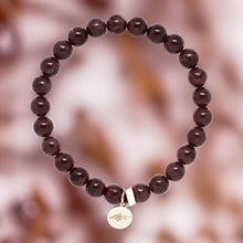 Load image into Gallery viewer, Garnet Birthstone Flat Silver Bead Bracelet 8mm featuring deep red natural garnet beads on a soft blurred background by Mystic Flavia.