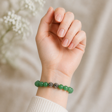 Load image into Gallery viewer, MysticFlavia green aventurine bead bracelet worn on a woman's wrist in a soft lifestyle setting