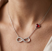 Load image into Gallery viewer, Woman wearing infinity heart crystal necklace, close-up on neck