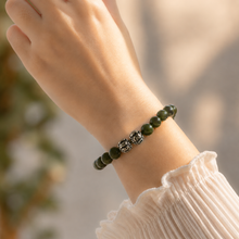 Load image into Gallery viewer, Jade Super Stone Silver Bead Bracelet 8MM worn on a female wrist in a natural lifestyle setting with silver dragon beads