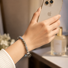 Load image into Gallery viewer, Female model wearing Labradorite Flat Silver Bead Bracelet 8mm with natural labradorite gemstone beads and 925 sterling silver flat bead by Mystic Flavia in a lifestyle setting.