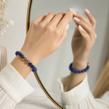 Load image into Gallery viewer, Lapis lazuli super silver bead bracelet worn on wrist reflected in mirror with white outfit background