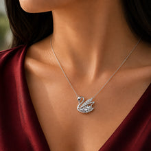 Load image into Gallery viewer, Woman wearing MysticFlavia moissanite swan pendant necklace, close-up on neck.