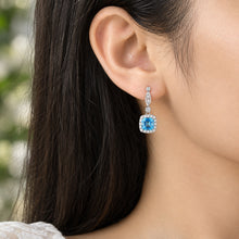 Load image into Gallery viewer, Sapphire Blue Silver Drop Earring with Halo and Marquise Detail on Model