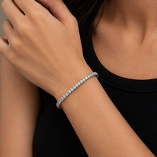 Load image into Gallery viewer, MysticFlavia moissanite tennis bracelet worn on wrist, styled with black outfit, silver setting.