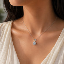 Load image into Gallery viewer, Woman wearing MysticFlavia moissanite pendant necklace, close-up on neck, small round pendant.