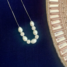 Load image into Gallery viewer, Natural pearl necklace with alternating pearl and zircon beads on a blue background