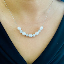 Load image into Gallery viewer, Natural pearl silver necklace worn elegantly on a model | MysticFlavia