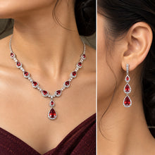 Load image into Gallery viewer, Red gemstone silver necklace and matching earrings worn by a model in a close-up view