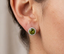 Load image into Gallery viewer, Woman wearing paved green crystal stud earring, close-up on ear.