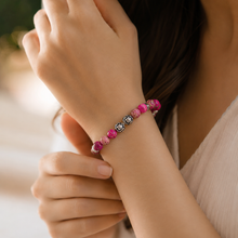 Load image into Gallery viewer, Woman wearing the Natural Pink Jasper Stone Silver Bead Bracelet 8MM, displaying vibrant natural pink jasper beads and decorative silver beads in a stylish lifestyle setting.