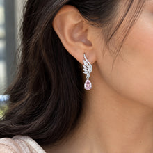 Load image into Gallery viewer, 925 sterling silver wing drop earrings with sparkling teardrop gemstones worn on a model’s ear