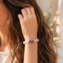 Load image into Gallery viewer, Close-up of female hand styling pastel pink bead bracelet with silver accents and loose hair