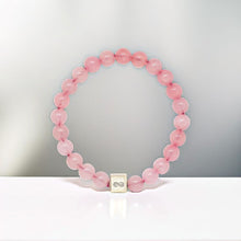 Load image into Gallery viewer, Rose quartz bracelet with natural pink crystal beads and silver infinity cube in studio display