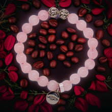 Load image into Gallery viewer, Rose quartz bracelet styled with floral backdrop and silver accents by MysticFlavia