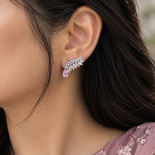 Load image into Gallery viewer, Silver diamond leaf earring with pink gemstone worn on a model’s ear
