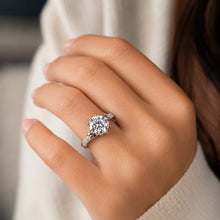 Load image into Gallery viewer, Moissanite solitaire ring worn on a woman’s hand with a delicate silver band