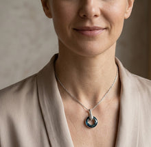 Load image into Gallery viewer, Woman wearing teal circle pendant necklace, close-up on neck