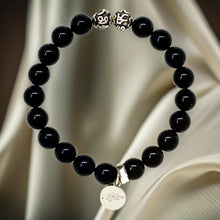 Load image into Gallery viewer, Black tourmaline bracelet with 925 sterling silver beads and charm, gold satin lifestyle shot