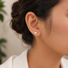 Load image into Gallery viewer, MysticFlavia natural pearl stud silver earring 11 MM worn on a model’s ear