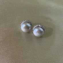 Load image into Gallery viewer, White natural pearl silver stud earrings worn on a woman's ear