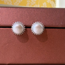 Load image into Gallery viewer, White natural pearl silver stud earrings displayed on a soft pink background