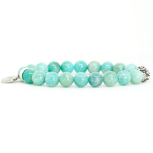 Load image into Gallery viewer, Amazonite bracelet side view with mint green beads, carved silver bead on right and round brand charm on left, white background