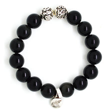 Load image into Gallery viewer, MysticFlavia black obsidian bracelet 12mm flat view with two engraved silver accent beads at top and round brand charm at bottom on white background