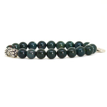 Load image into Gallery viewer, Side view of bloodstone round bead bracelet showing carved silver bead and bracelet thickness, white background