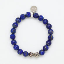 Load image into Gallery viewer, MysticFlavia lapis lazuli bracelet top view with engraved silver beads at bottom and round brand charm at top