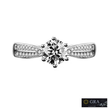Load image into Gallery viewer, Moissanite ring with round center stone and sparkling side stones on silver band