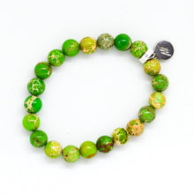 Load image into Gallery viewer, Angled view of Natural Olive Green Jasper Flat Silver Bead Bracelet 8MM showcasing polished jasper beads