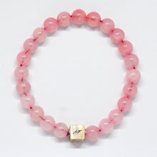 Load image into Gallery viewer, Natural rose quartz round bead bracelet with engraved silver cube charm on white background