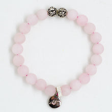 Load image into Gallery viewer, Rose quartz bracelet with matte pink beads and silver charm on white background by MysticFlavia