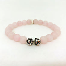 Load image into Gallery viewer, Close view of Rose quartz bracelet with matte round beads and engraved silver bead accents