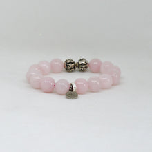Load image into Gallery viewer, MysticFlavia round rose quartz bracelet with dangling silver charm on a white background
