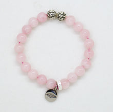 Load image into Gallery viewer, Rose quartz bracelet with silver charm and decorative beads on white background