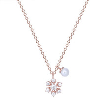 Load image into Gallery viewer, Rose gold snowflake pearl pendant silver necklace on a white background