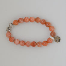 Load image into Gallery viewer, Side view of Sunstone silver bead bracelet 8MM showing the bead arrangement and silver charm
