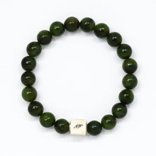 Load image into Gallery viewer, Jade infinity bracelet flat lay showing round beads and small silver charm